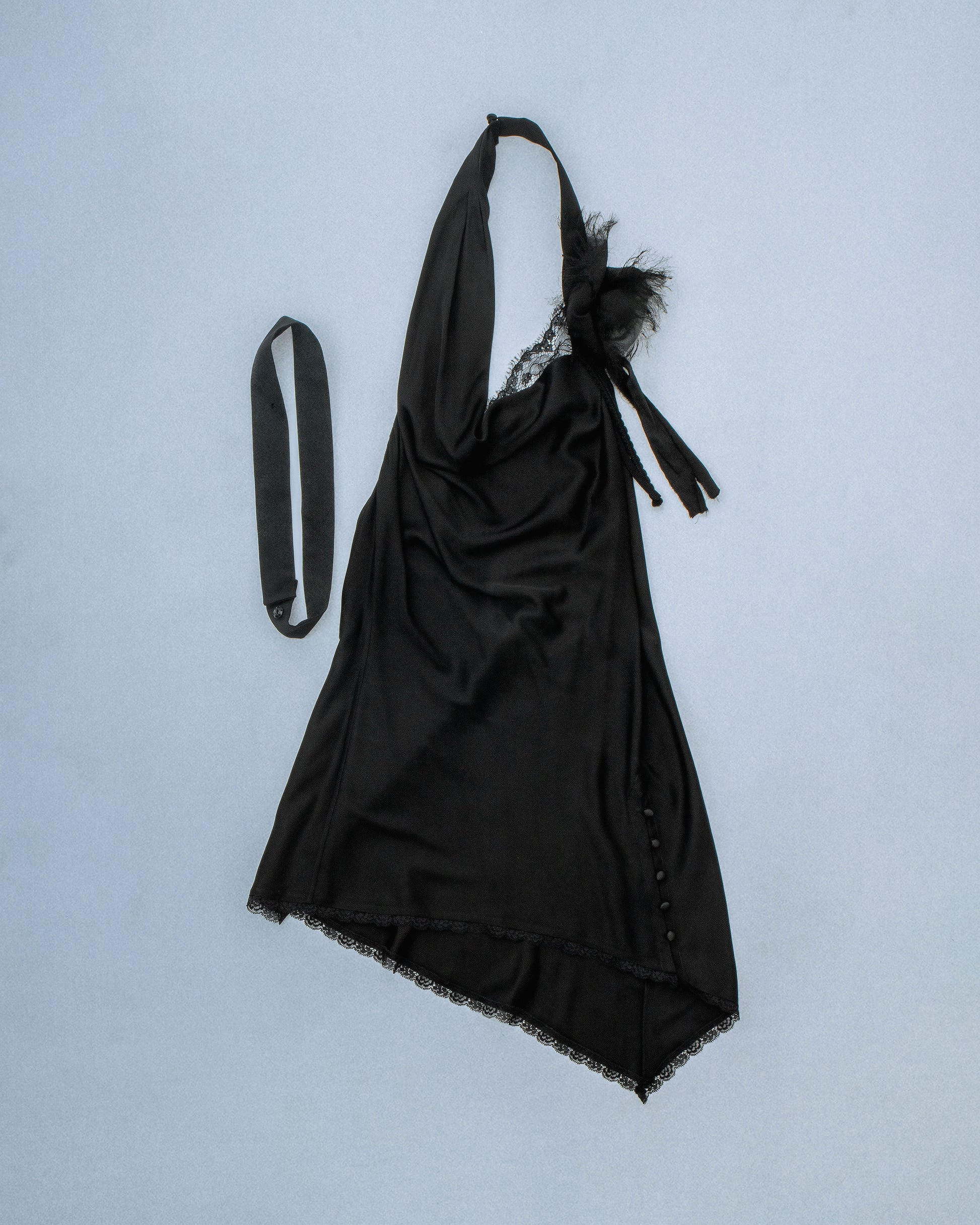 Silk cowl neck mini dress with distressed flower and silk/yarn trims hanging. Fabric is sewn on bias. Features silk buttons to conceal dress slit or cover for a more modest look. Comes with detachable silk snap belt. Deadstock trims from Japan. Perfect for elevated day-to-night looks. Shop now at Sivan Studio.