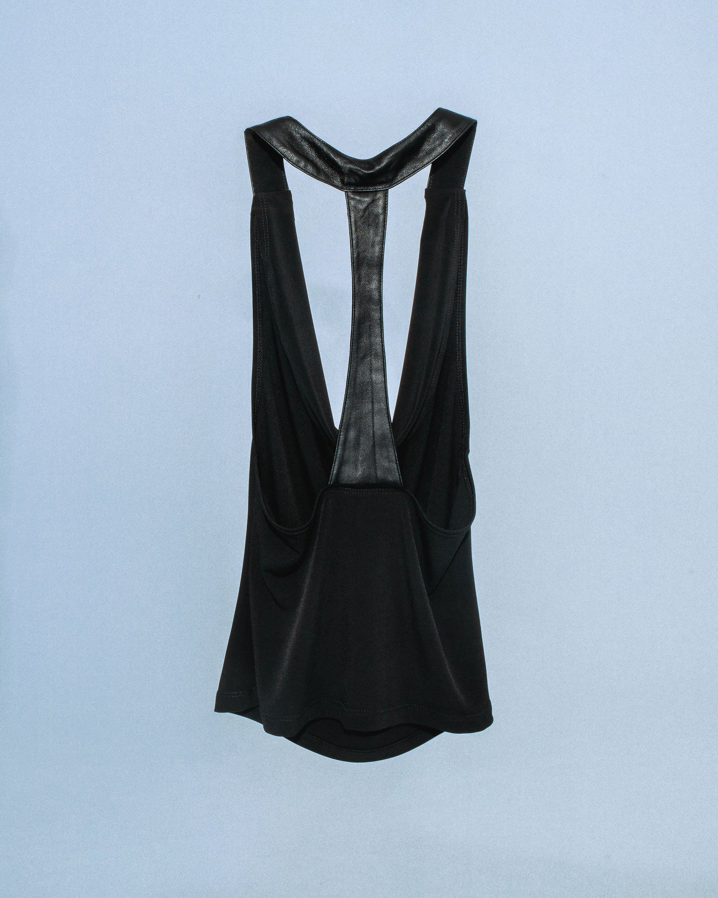 Stretch cowl neck top with lamb leather neck/back halter panel. Leather lined with top material to prevent sticking to skin. Super soft fabric drapes and forms to body. Perfect for elevated day-to-night looks. Shop now at Sivan Studio.