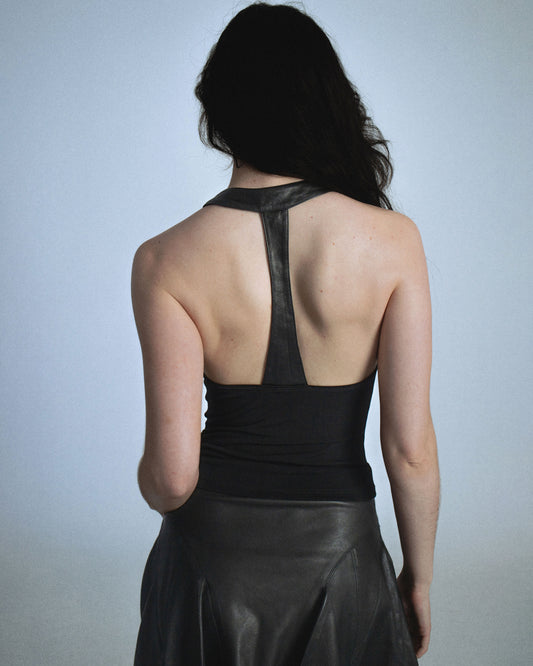 Stretch cowl neck top with lamb leather neck/back halter panel. Leather lined with top material to prevent sticking to skin. Super soft fabric drapes and forms to body. Perfect for elevated day-to-night looks. Shop now at Sivan Studio.