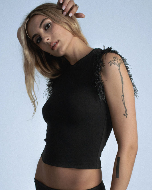Fitted stretch cotton tank with layered trim made of lace, tulle, and distressed eyelash fringe along the sleeve opening. Adds an undone, tactile detail to a clean silhouette. Perfect for elevated day-to-night looks. Shop now at Sivan Studio.