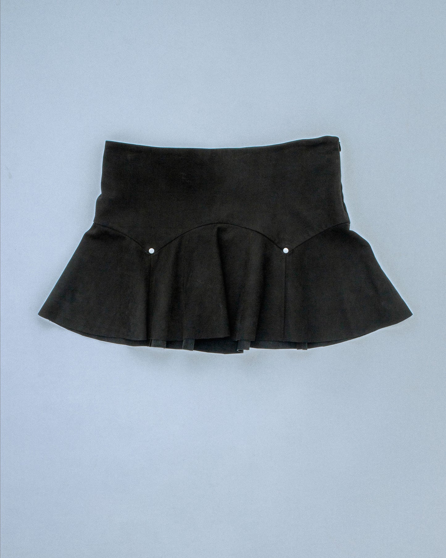 Suede flared circle yoke skirt with paneled seams. Finished with metal rivets at the seam and invisible side zipper. Raw edge at hem. Perfect for elevated day-to-night looks. Shop now at Sivan Studio.