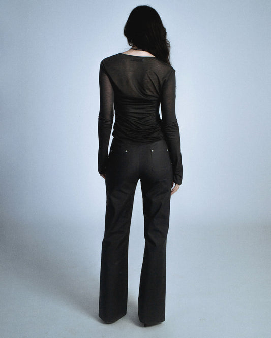 Stretch twill pants with matte silver rivets tracing the side seams. Features front welt pockets and back patch pockets. Custom laser engraved button hardware. Perfect for elevated day-to-night looks. Shop now at Sivan Studio.