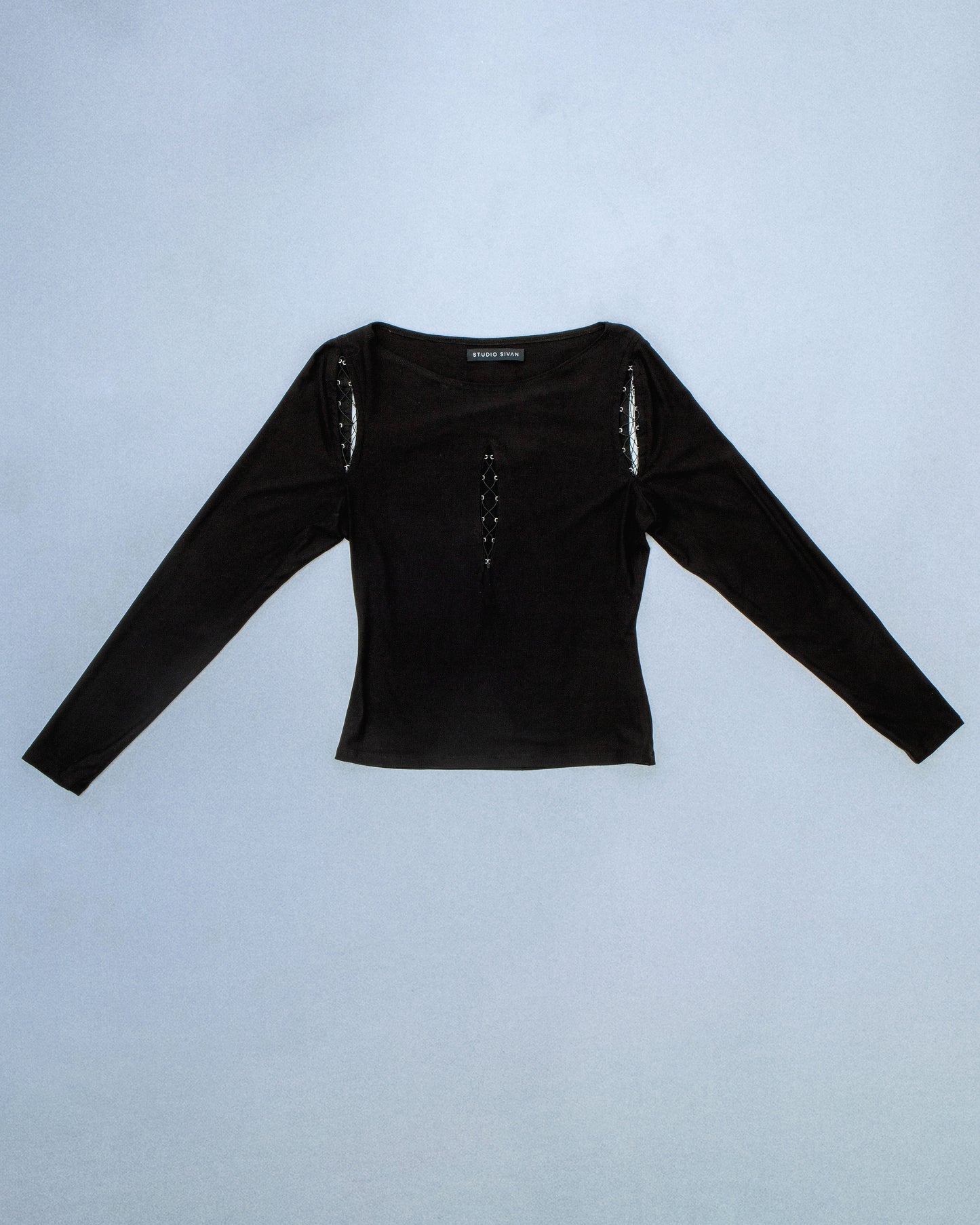 Long sleeve boat neck top made of anti-pill Jersey. Concealed Hook eye tape for lace up design. Stretch elastic thread for lace up. Perfect for elevated day-to-night looks. Shop now at Sivan Studio.