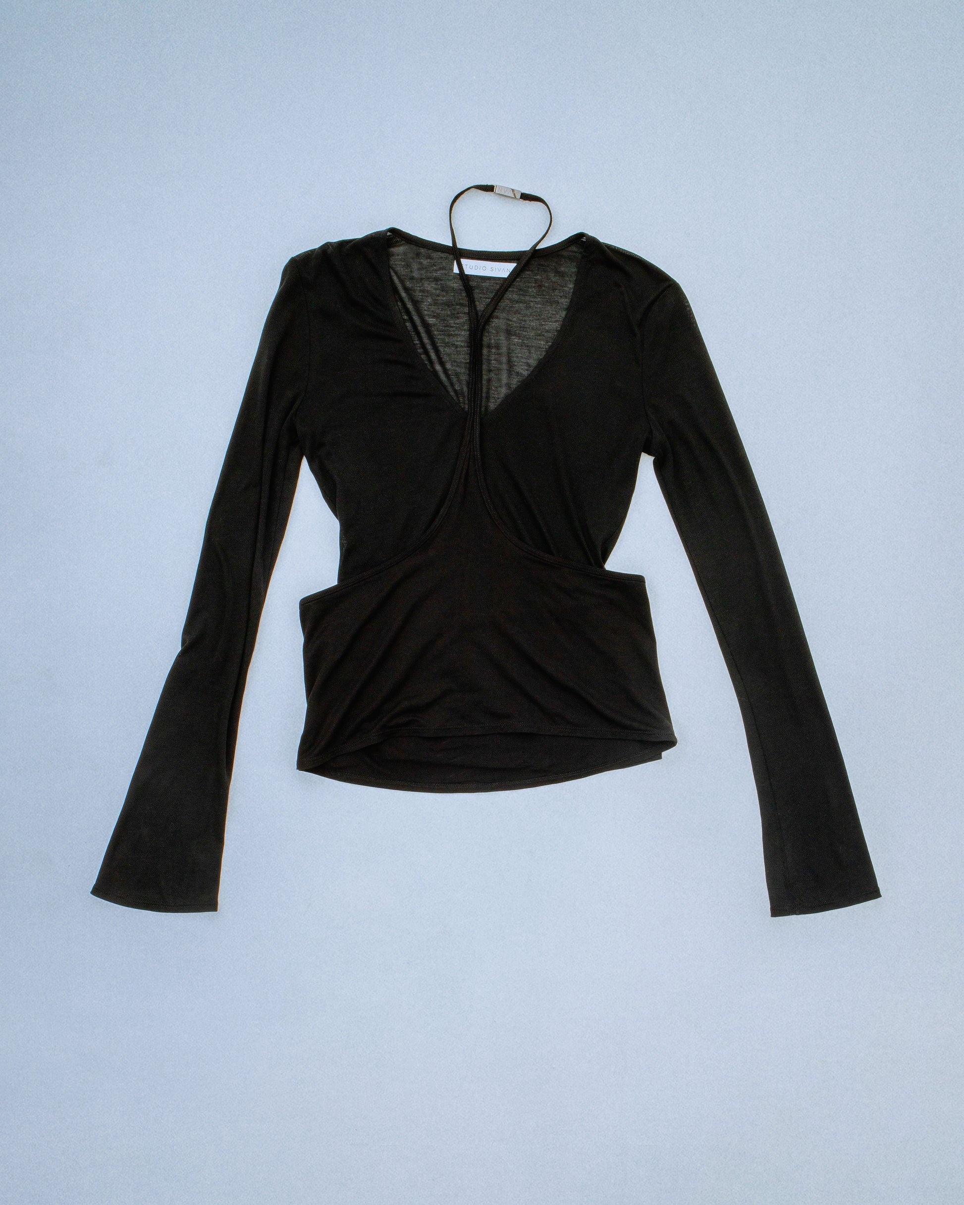 Sheer long sleeve soft knit top with a detachable overlay. Features a laser logo engraved neck clasp to secure back neck in gunmetal. Super soft, stretchy, and breathable fabric. Feels like a second skin. Perfect for elevated day-to-night looks. Shop now at Sivan Studio.