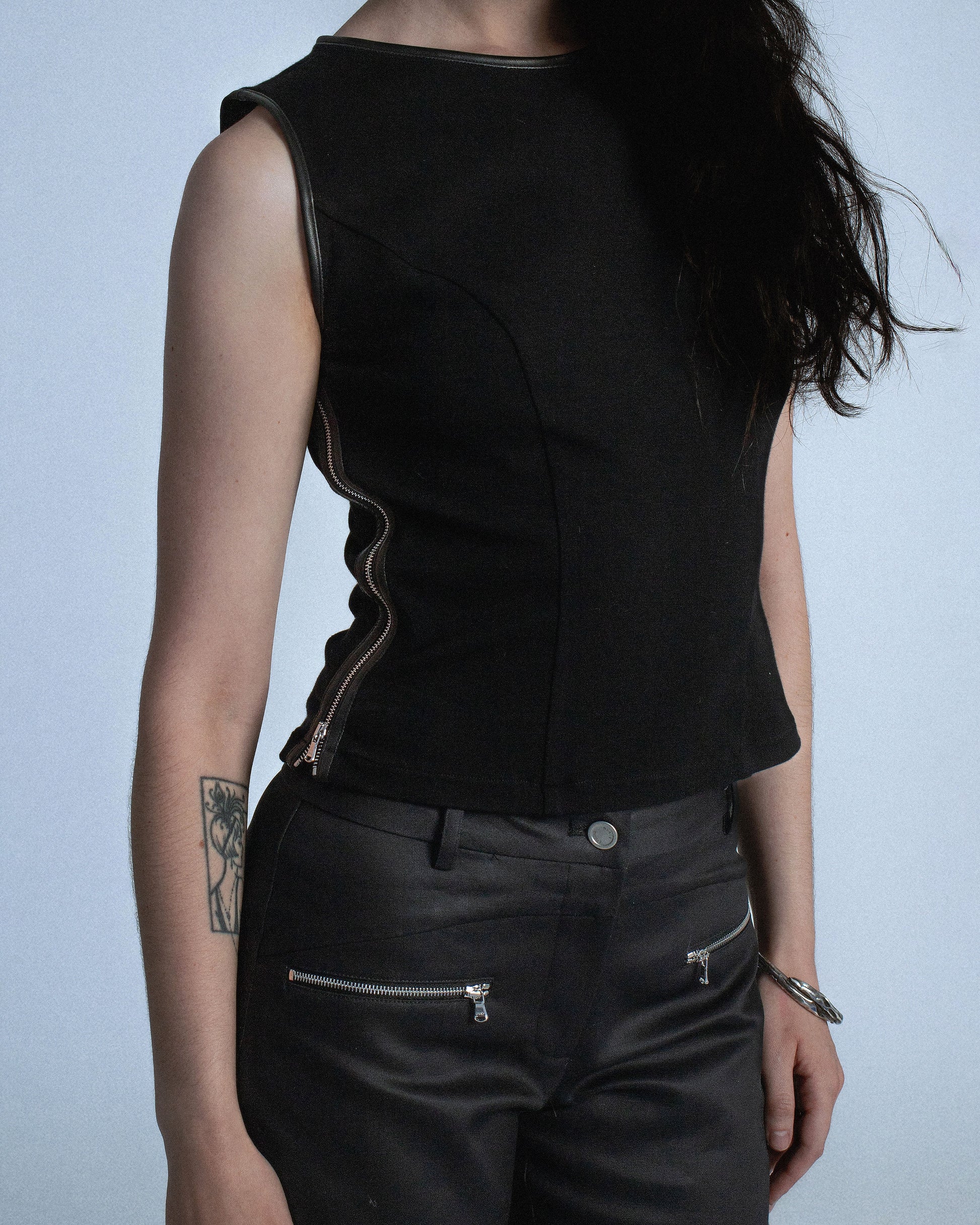 Ponte stretch tank top with lamb leather binding. Princess seams to hug figure. Features side seam zippers and back zipper. Sleeves and neckline also wrapped in leather. Perfect for elevated day-to-night looks. Shop now at Sivan Studio.