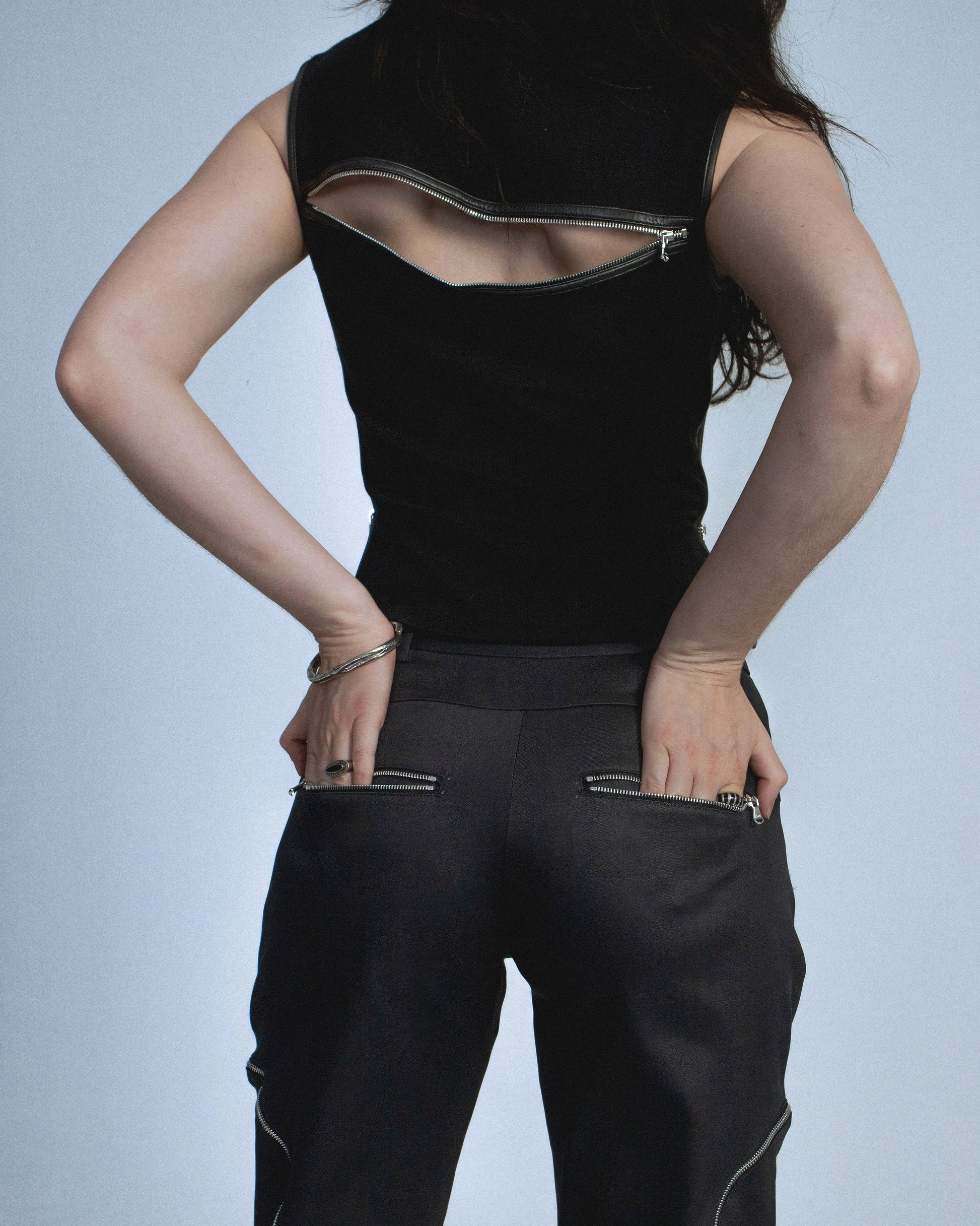Flared waxed stretch denim zipper pant.  Zipper opens up until knee to flare pant leg even more. Features exposed front and back silver zippers. Custom laser engraved button hardware. Perfect for elevated day-to-night looks. Shop now at Sivan Studio.