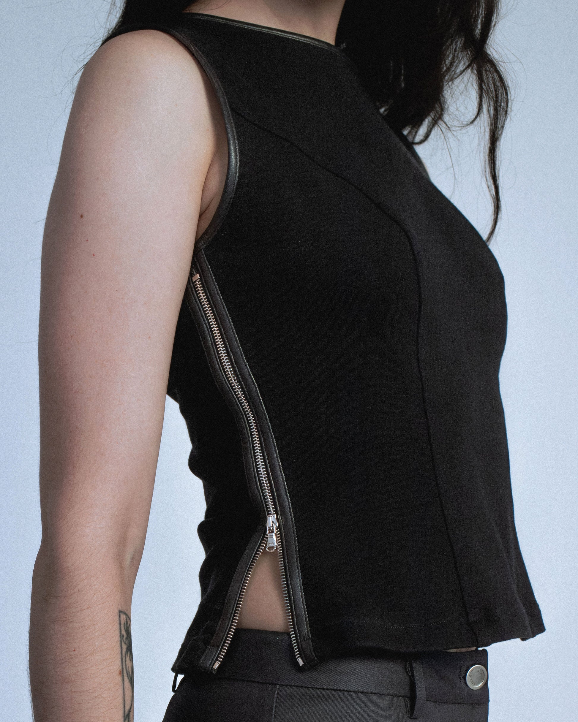 Ponte stretch tank top with lamb leather binding. Princess seams to hug figure. Features side seam zippers and back zipper. Sleeves and neckline also wrapped in leather. Perfect for elevated day-to-night looks. Shop now at Sivan Studio.