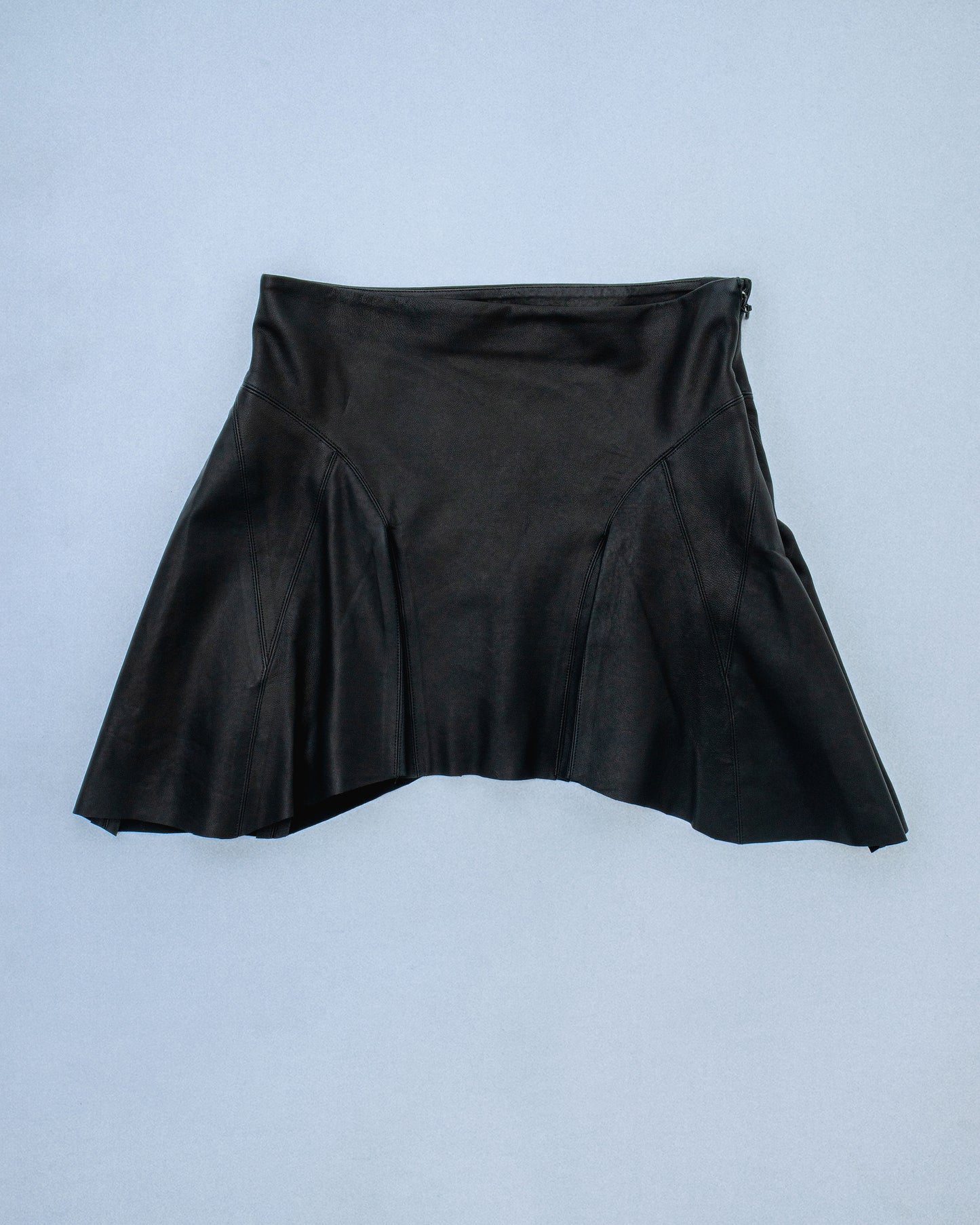 Lamb leather skirt with paneled construction and godets. Features a soft flare and subtle movement. Sits at mid waist. Invisible zipper at side seam Perfect for elevated day-to-night looks. Shop now at Sivan Studio.